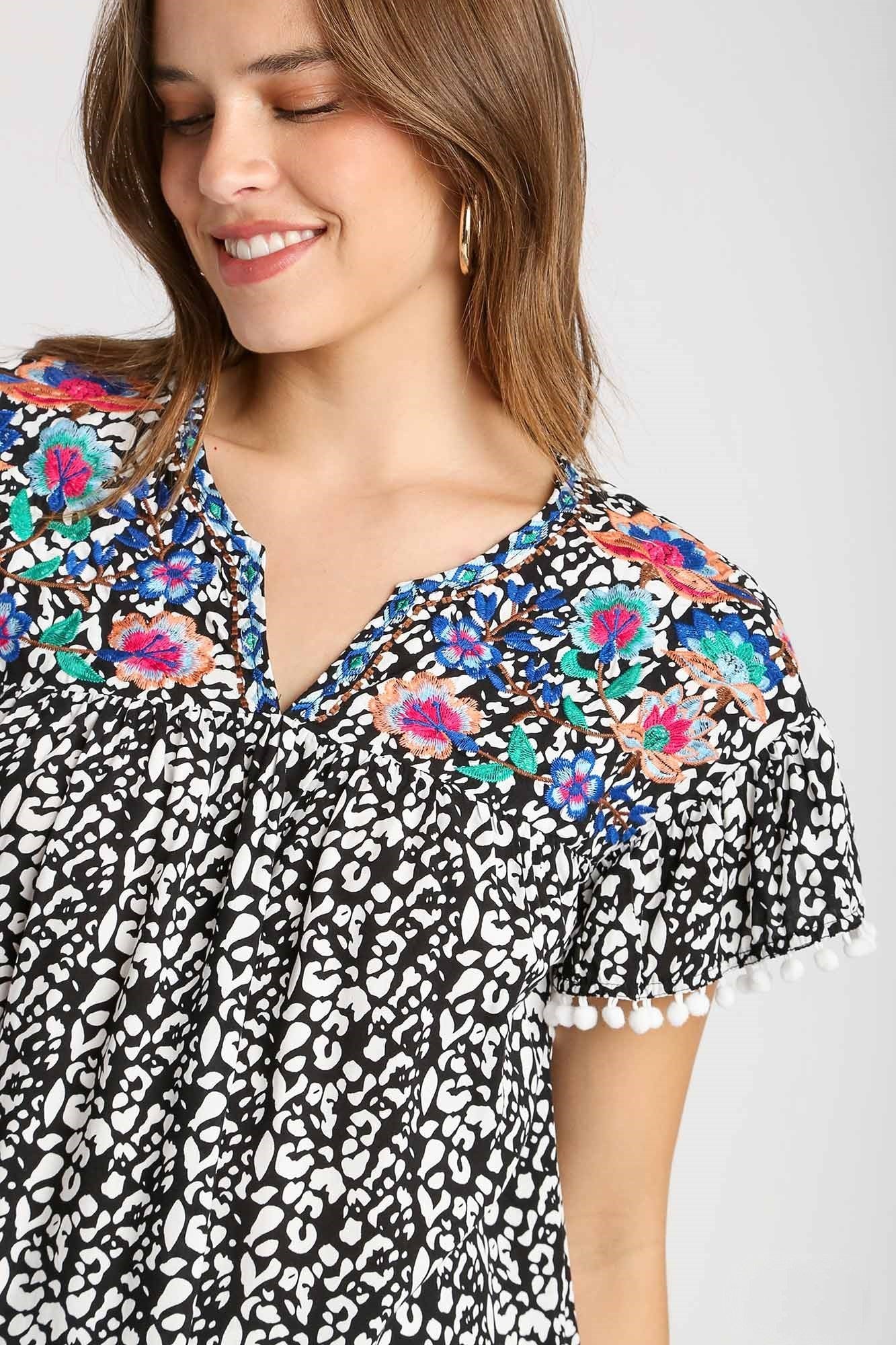 Umgee Animal Print Top with Flower Embroidery and Pom Pom Fringe Detai