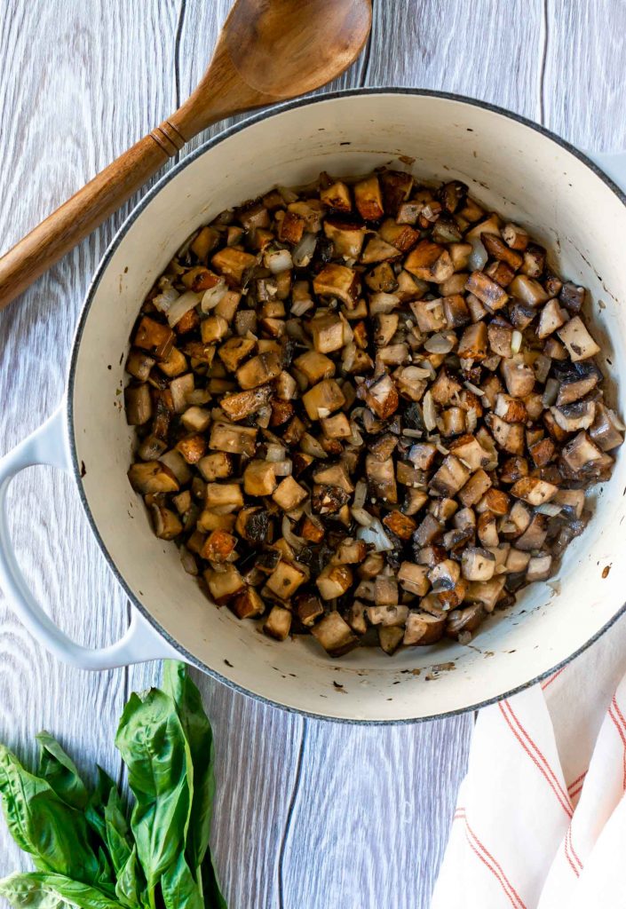 chopped mushrooms that are cooked in a large pot