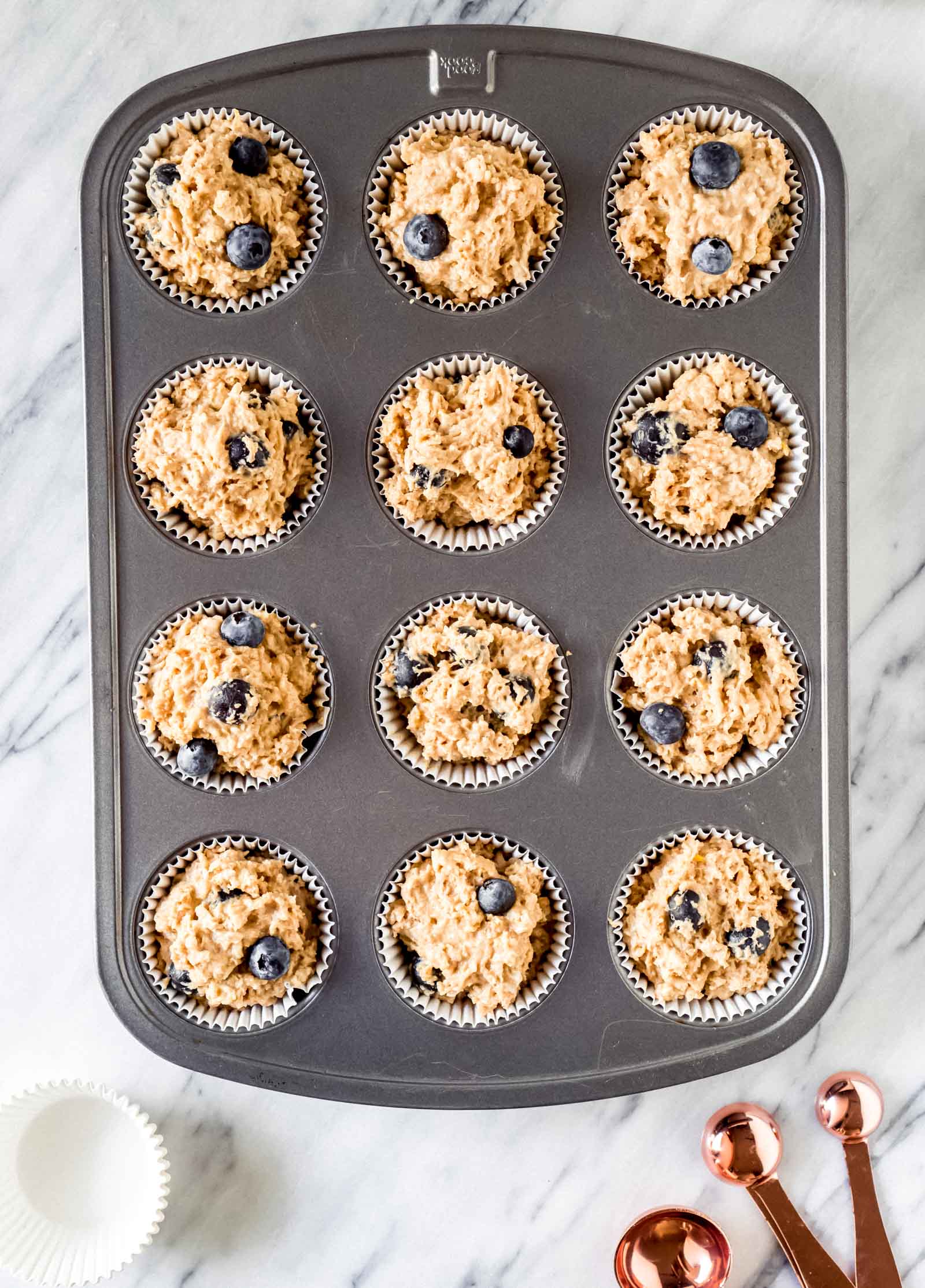 muffin batter in a muffin tin