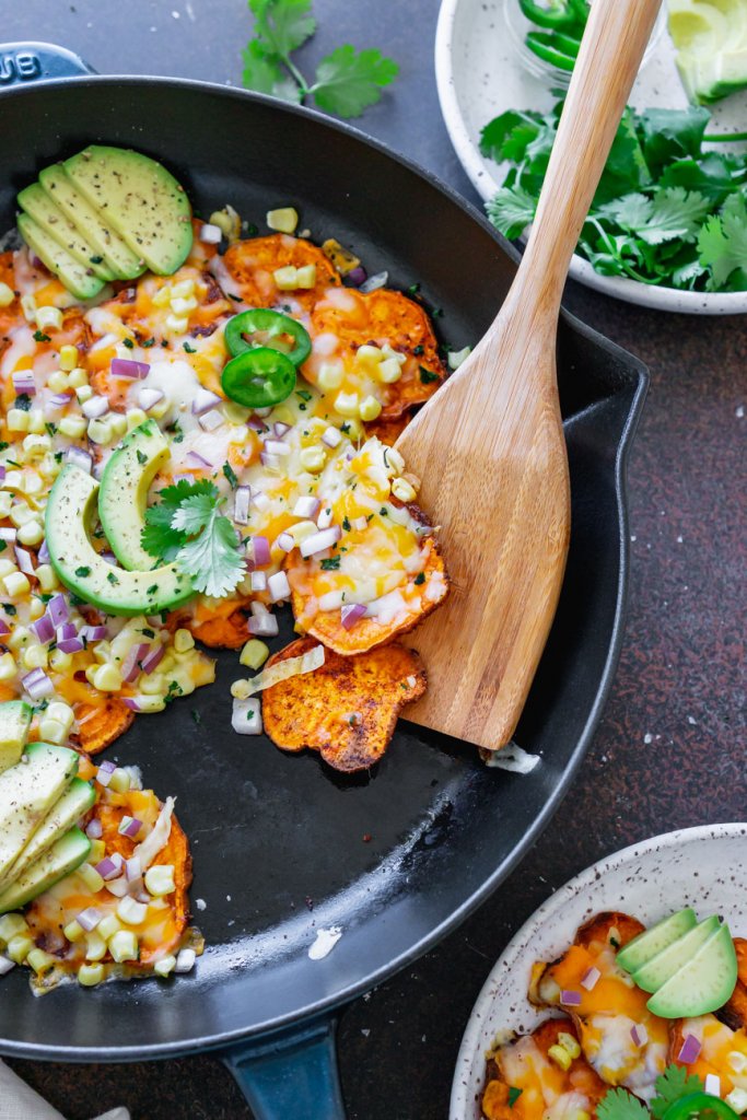 spooning mexican sweet potatoes onto a plate