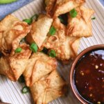 shrimp rangoon on a plate with sauce