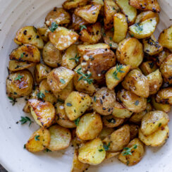 roasted garlic potatoes in a white bowl.