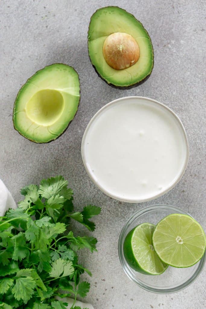 avocado, mexican crema, limes, cilantro in small bowls