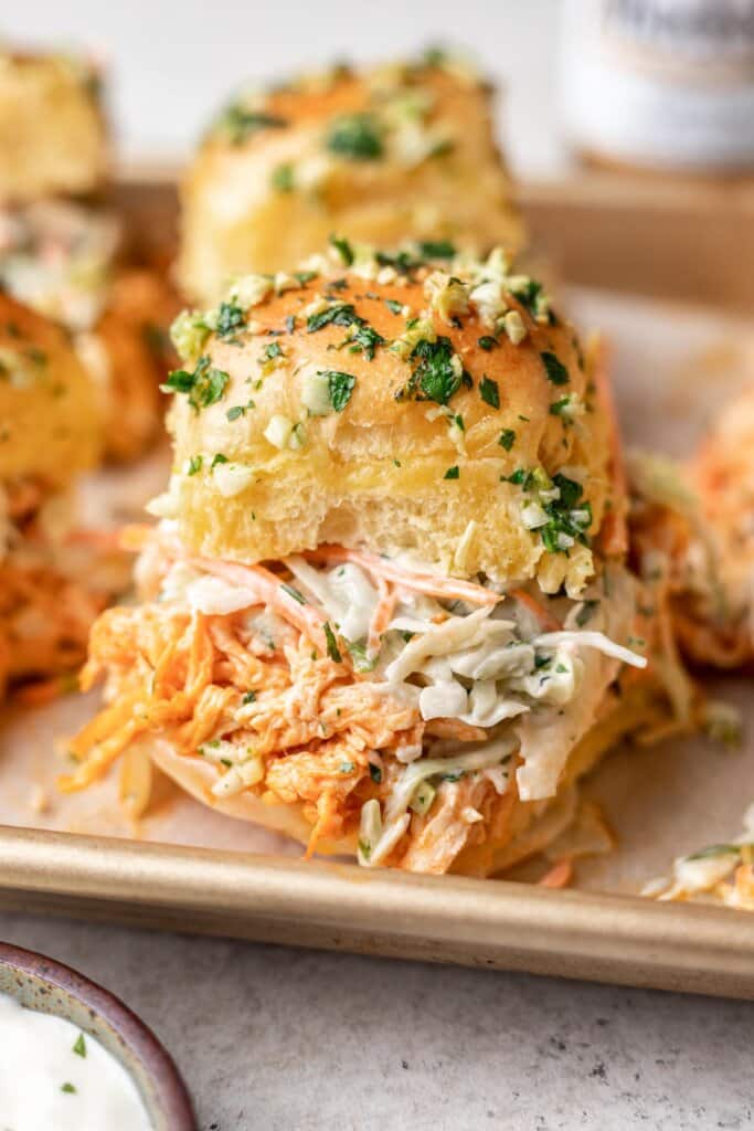 close up photo of a buffalo chicken slider on a sheet pan