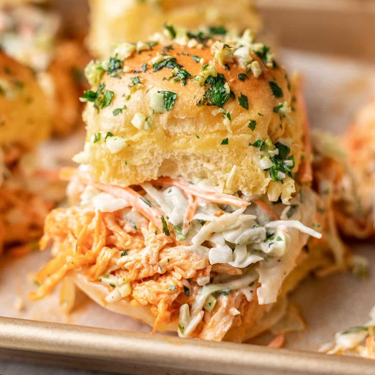close up photo of a buffalo chicken slider on a sheet pan