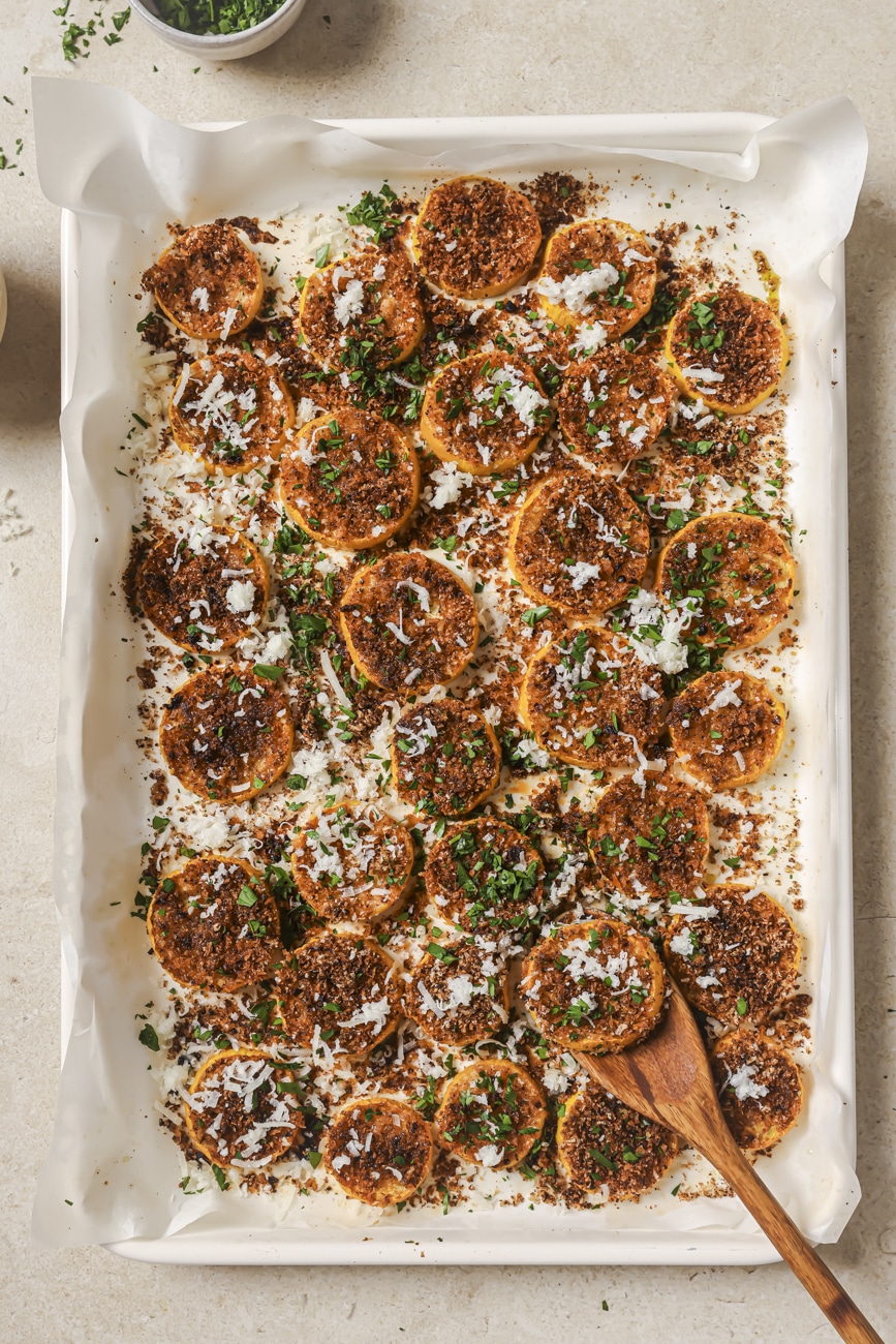 Roasted yellow squash garnished with Asiago cheese and fresh parsley.