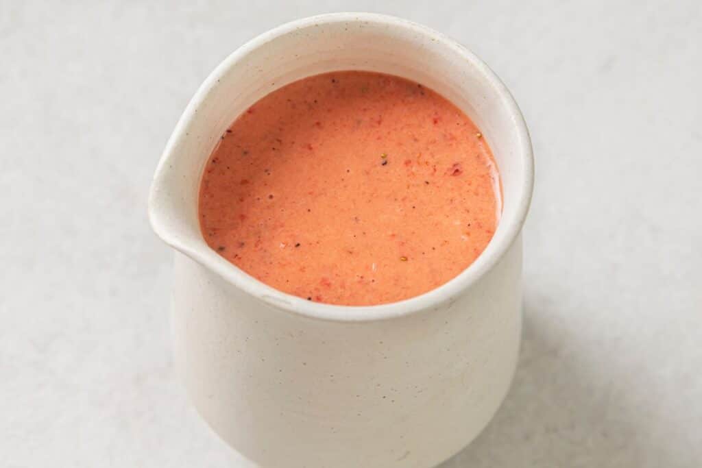 strawberry vinaigrette in a small white jar.