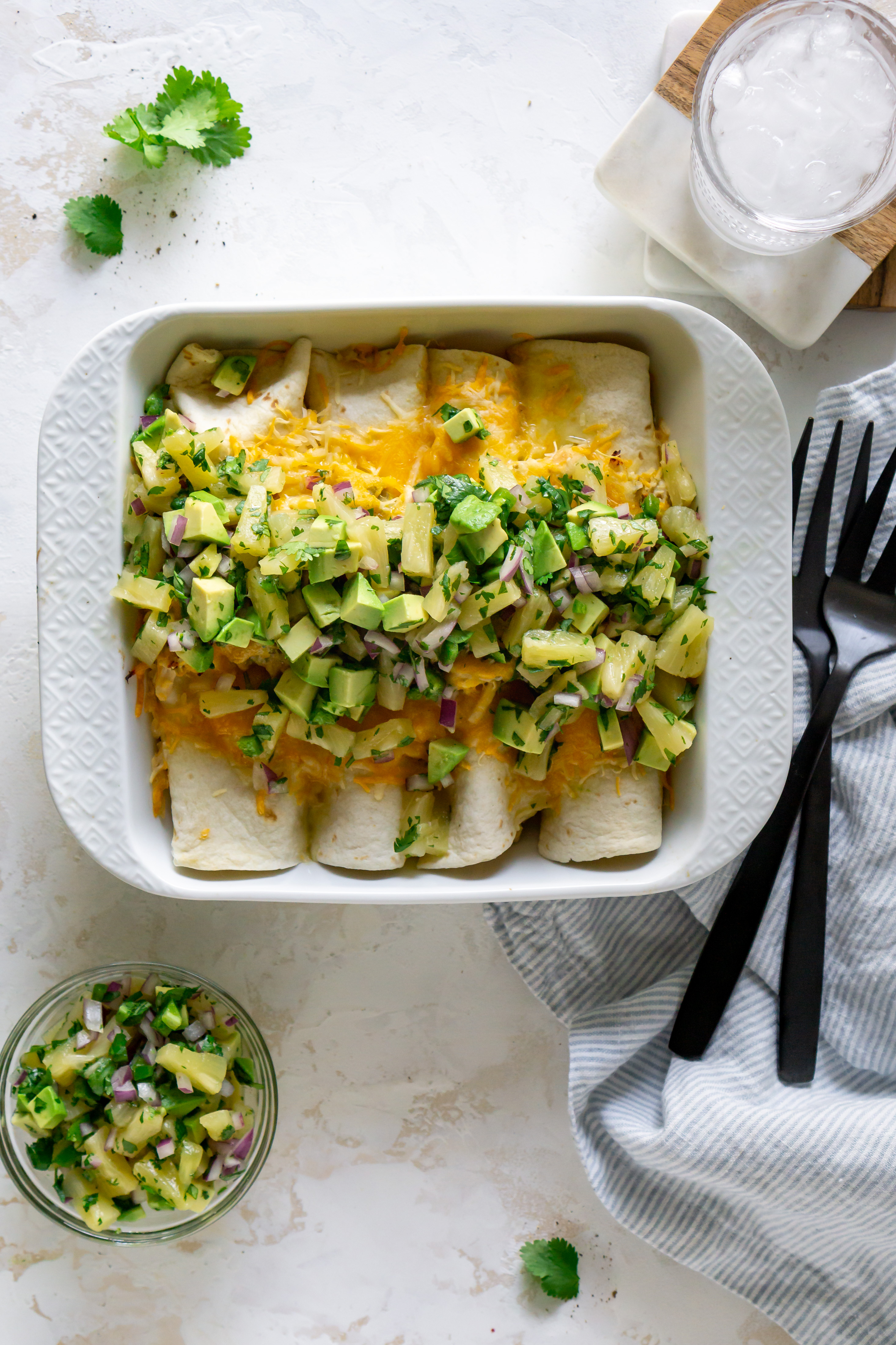 enchiladas in a white baking dish