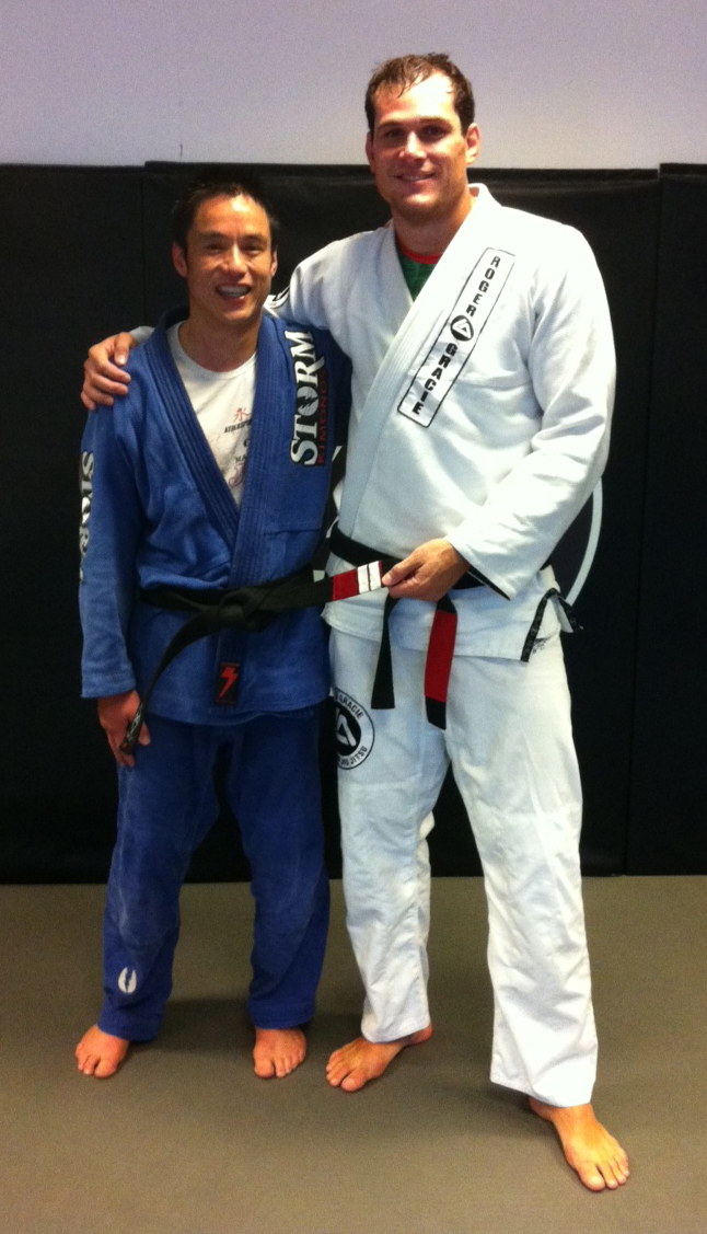 Kevin Chan receives 2 stripes on his black belt from Roger Gracie and