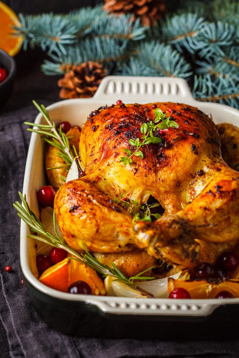 Christmas roasted chicken with cranberries, orange, spices and herbs