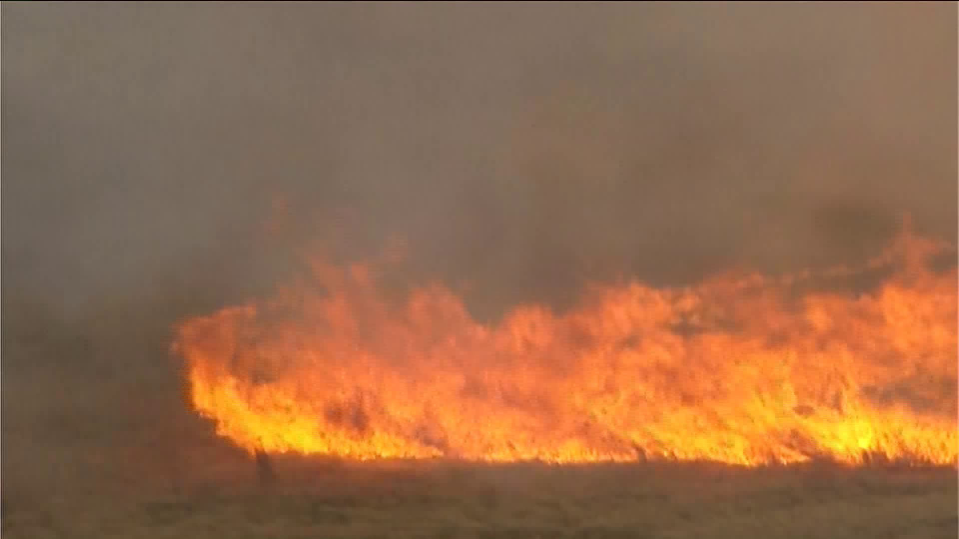 Firefighters battling large grass fire near Mulhall Oklahoma