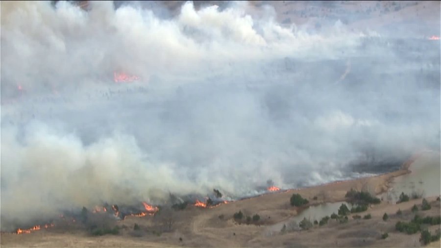 Firefighters battling large grass fire near Mulhall Oklahoma