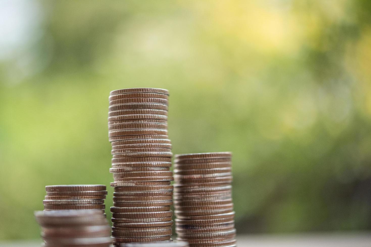 a-stack-of-coins-in-green-nature-free-photo.jpg