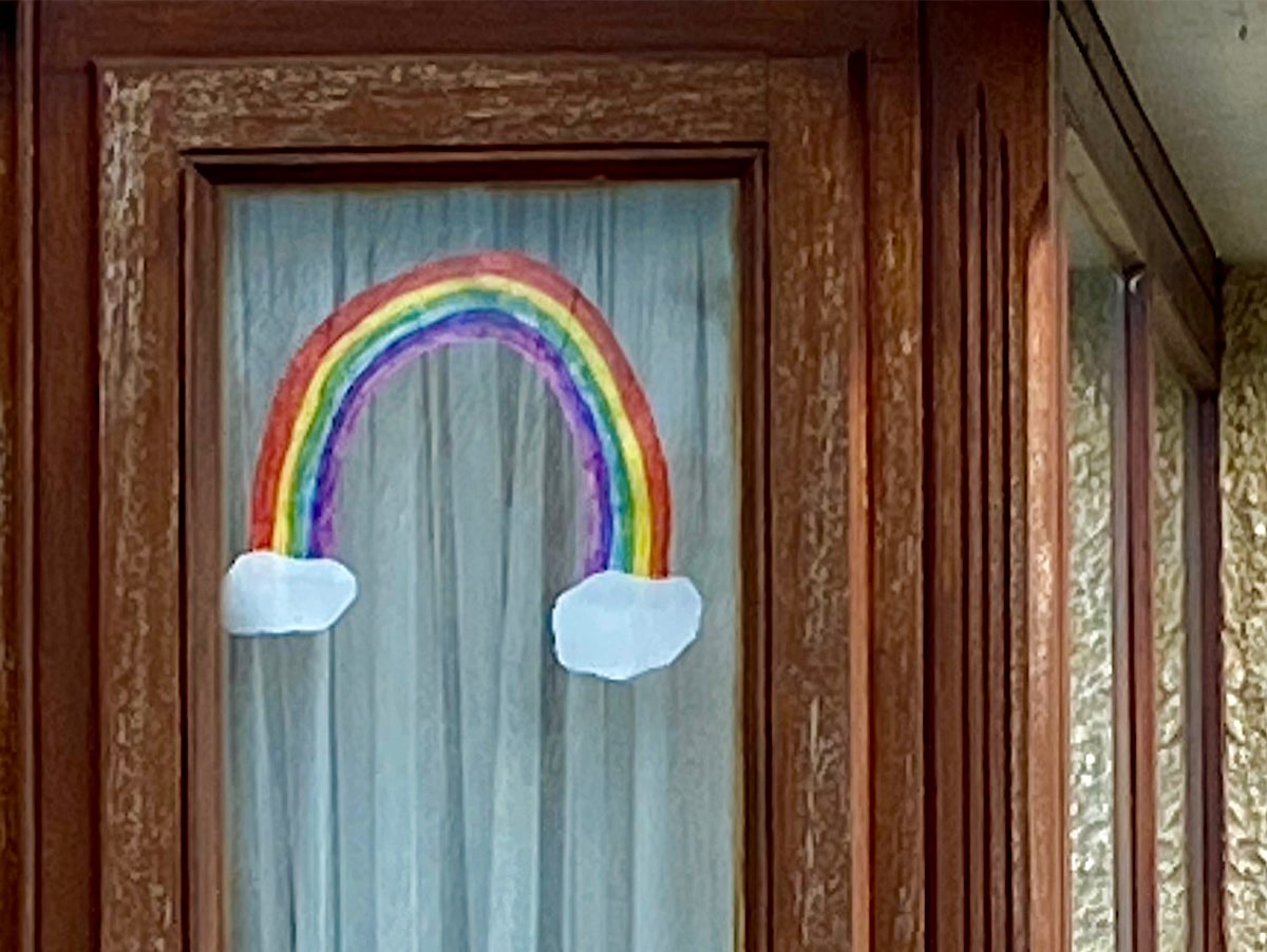 A classic rainbow with clouds at either end, cut out and stuck inside the window