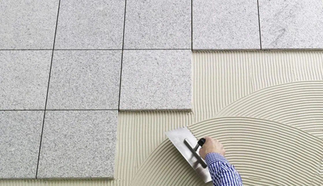 Why does tile adhesive still cause hollowing and falling off of bricks after use?