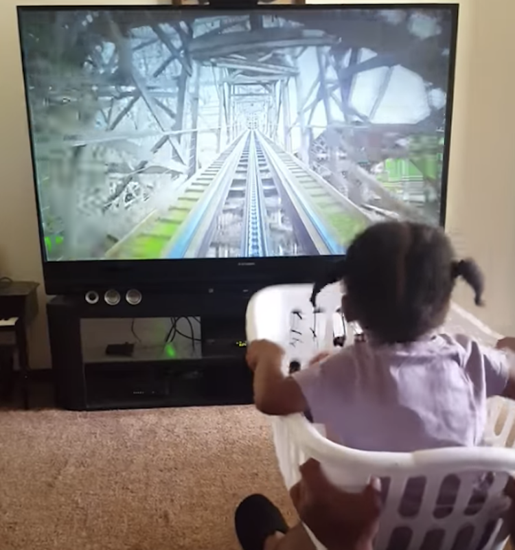 Little Girl Goes For a Ride on a Virtual Roller Coaster in a Laundry