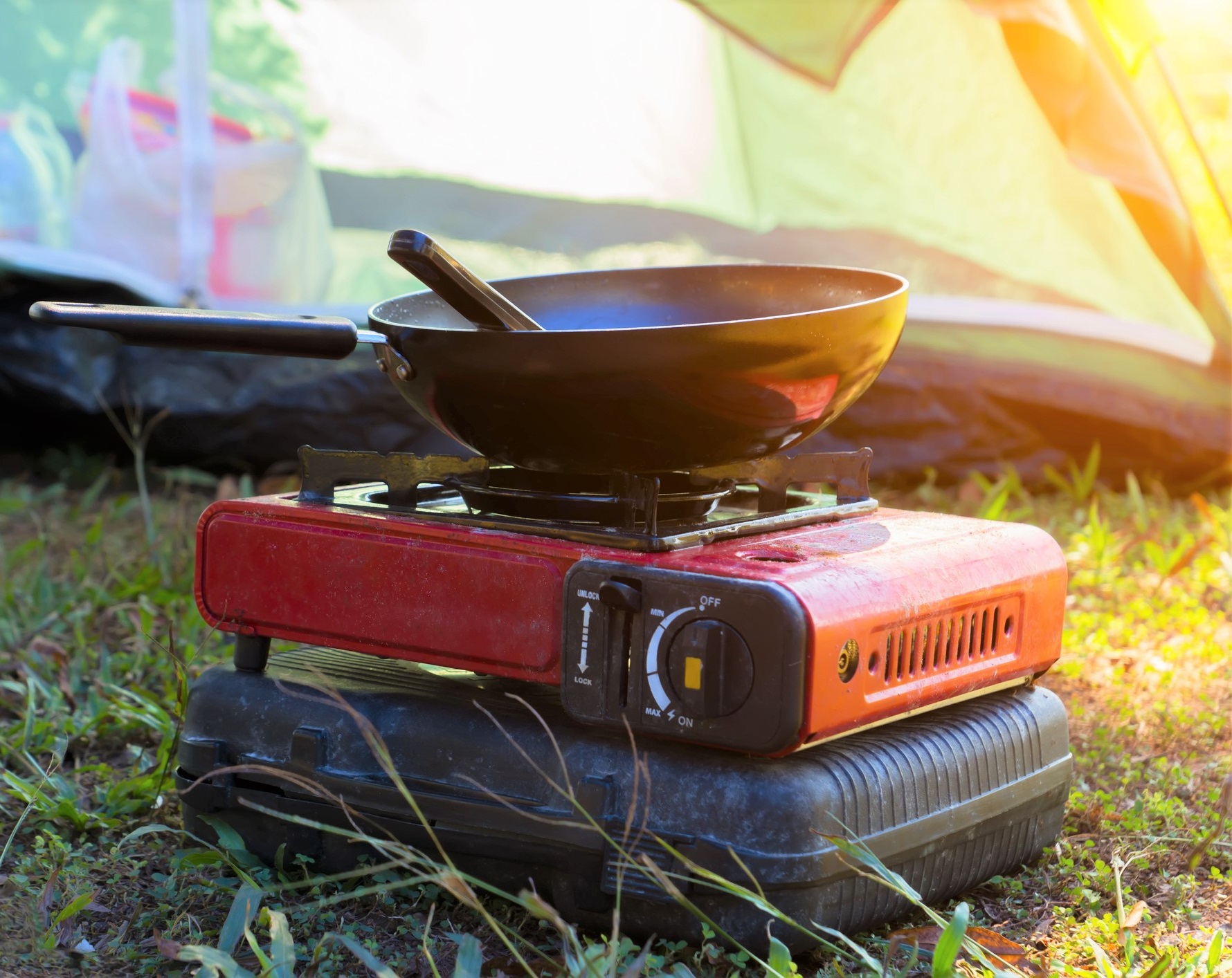 Portable gas camping stove and a frying pan in the camp. The Leaf