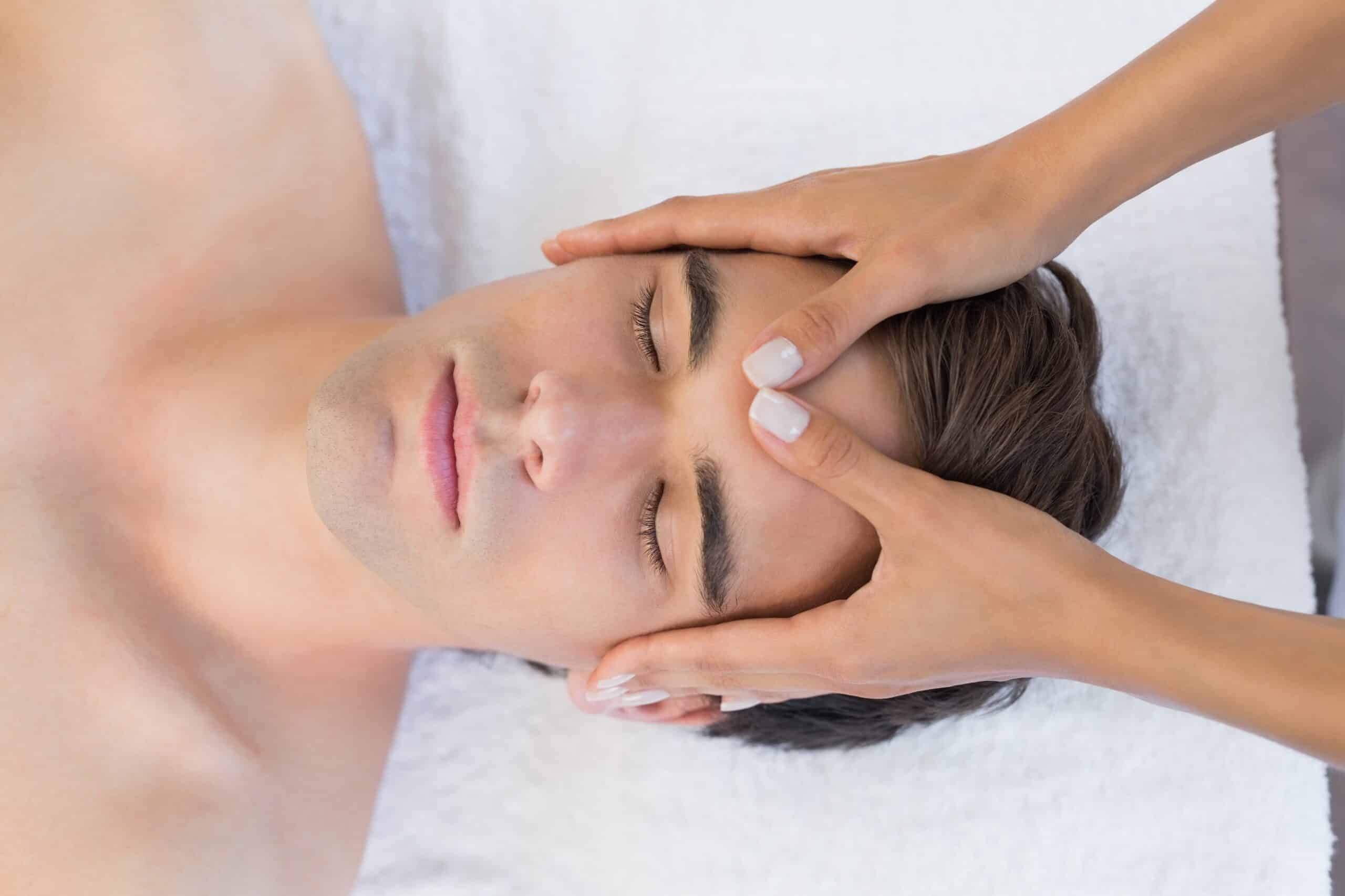 Man receiving head massage at spa center Learn Reiki Philadelphia