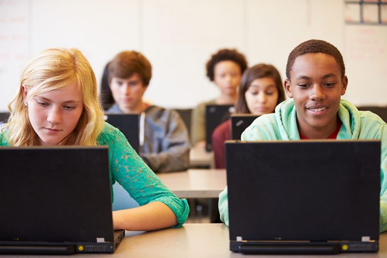 Group Of High School Students In Class Using Laptops LearnSafe