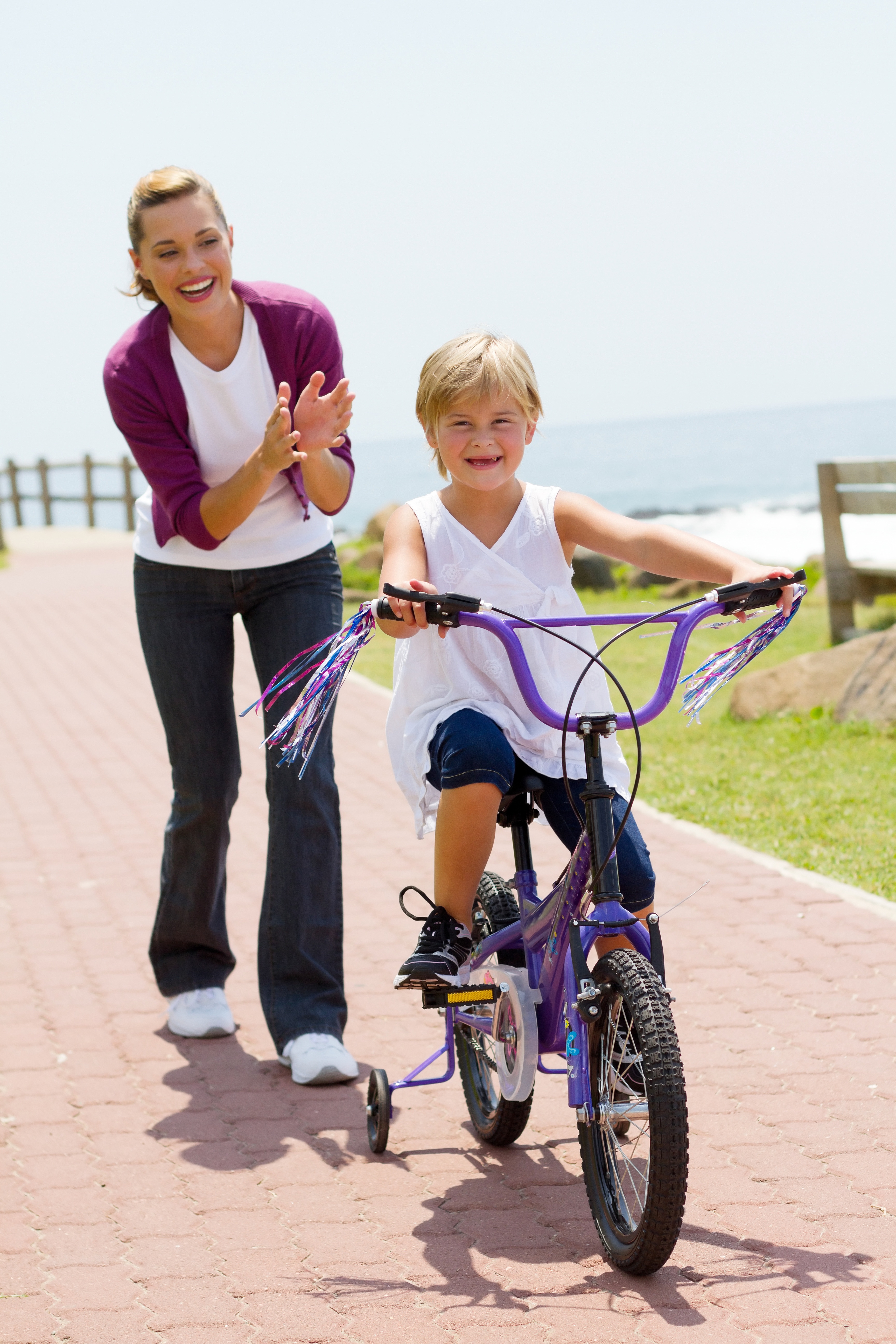 happy mom teaching daughter to ride bike Less Drama More Mama
