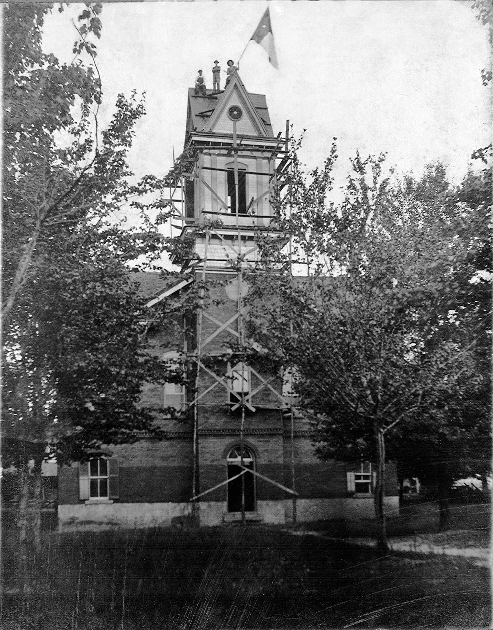 Adults Waving Flag Atop Clay County (NC) Courthouse
