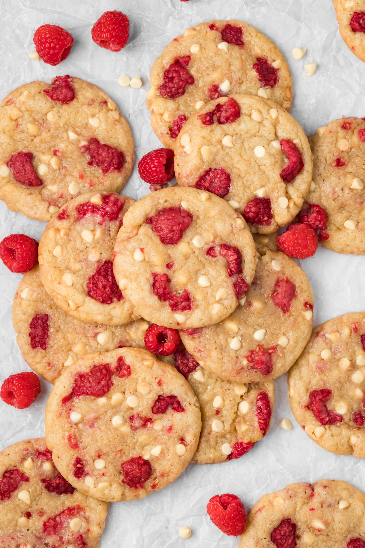White chocolate raspberry cookies stacked on top of each other.