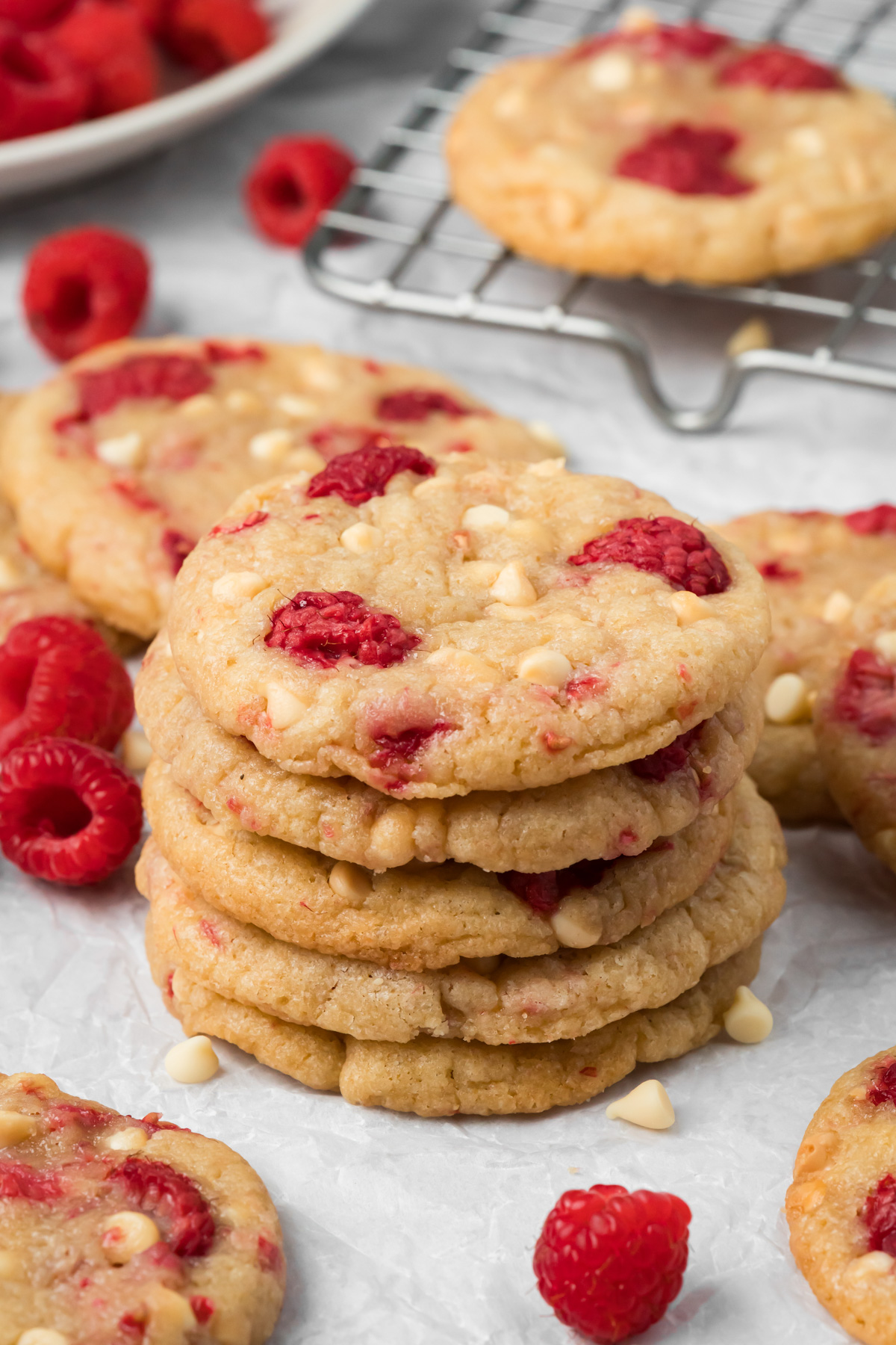 A stack of white chocolate raspberry cookies on top of each other.