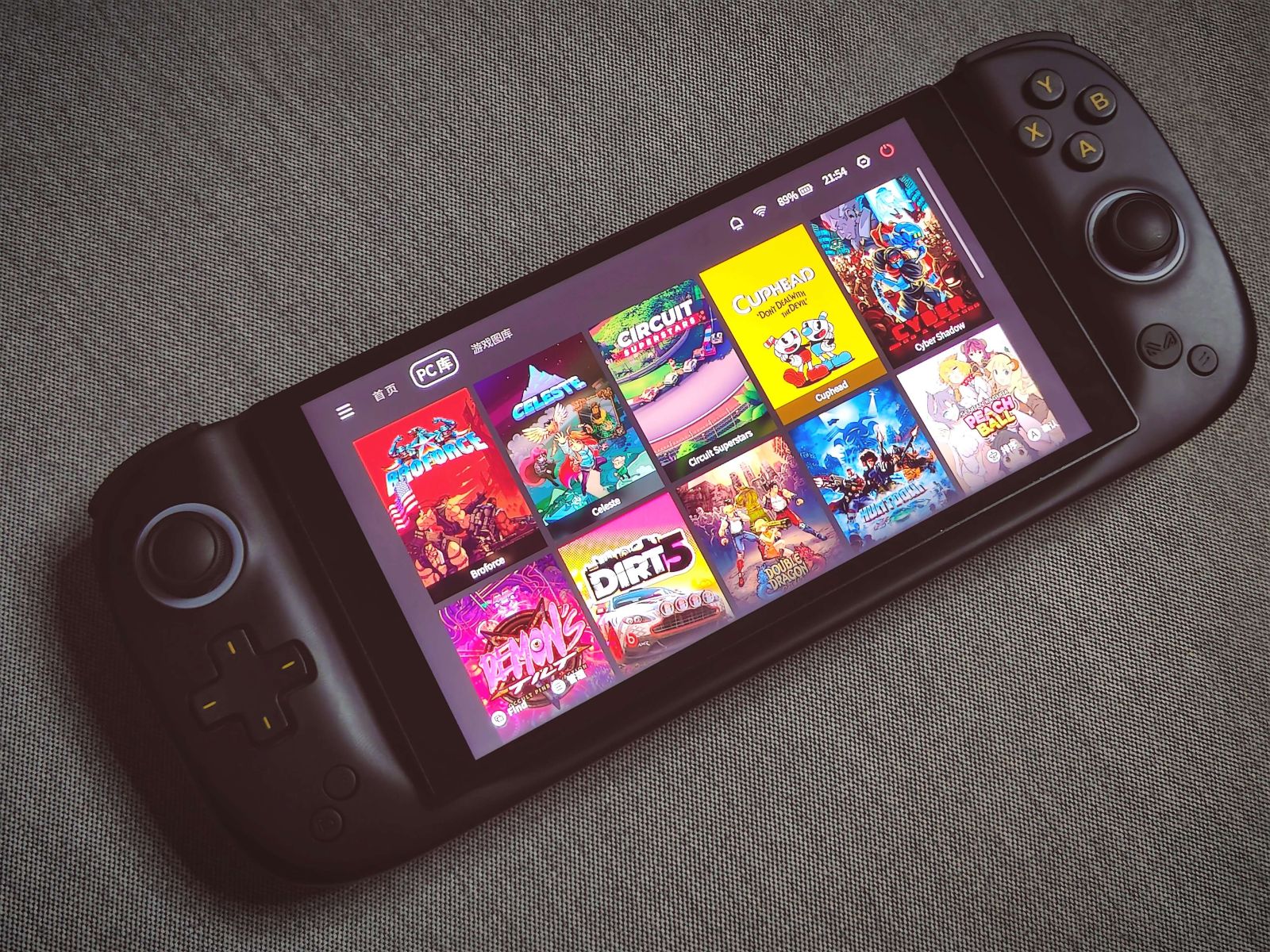 AYA Neo Flip handheld gaming PC with clamshell design and thumb