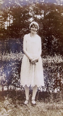 Black and white photo of young women in white dress from the 1920's