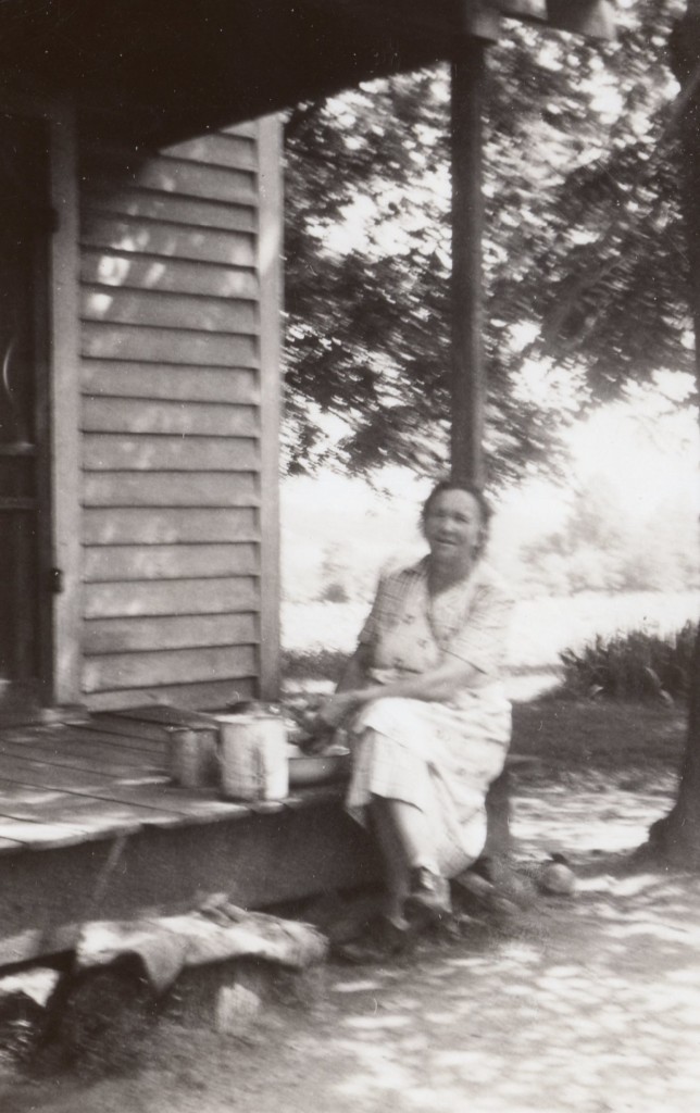 Stella White sitting on the back porch of her home