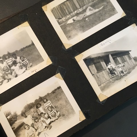 Black and white photos in an old black paper photo album