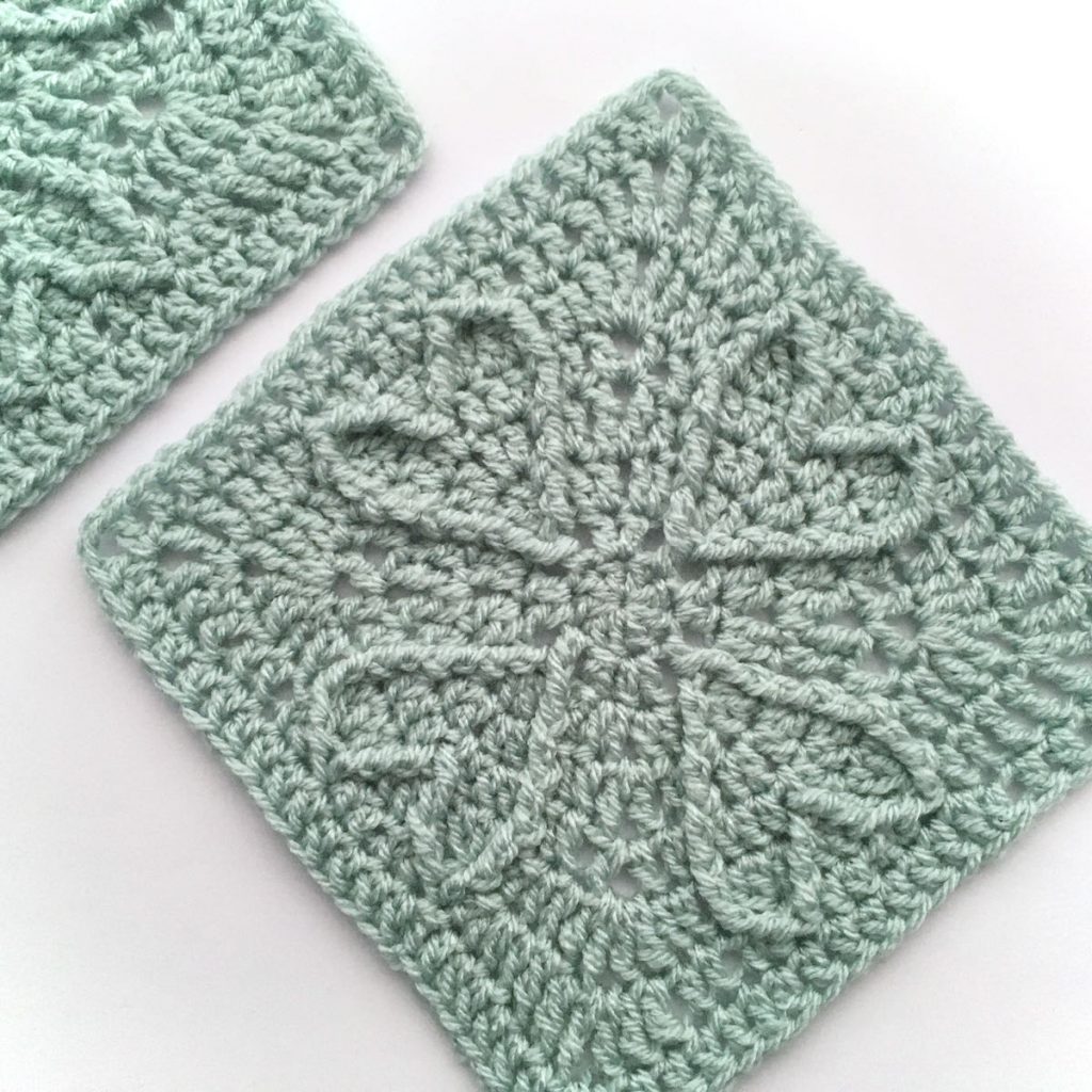 Crocheted squares with raised heart motifs