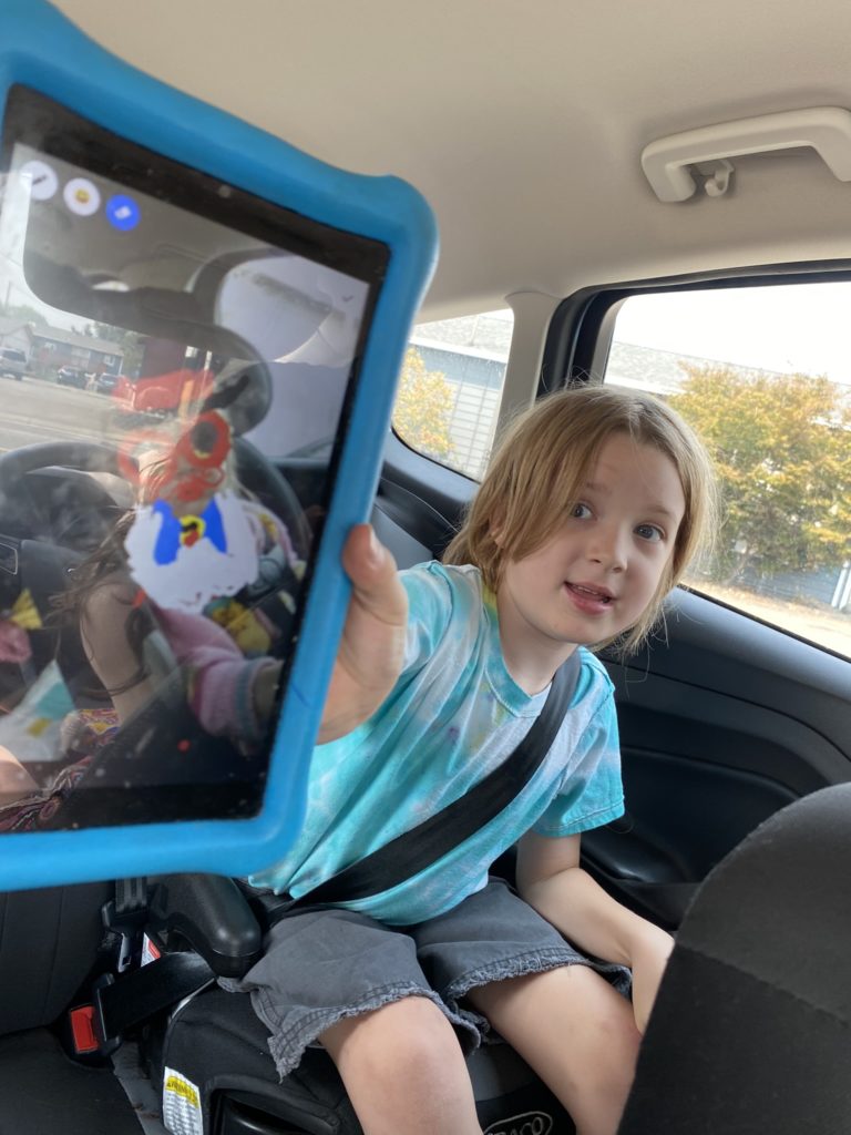 Car Interior - Young Boy Shows Us His Switch Tablet Drawing
