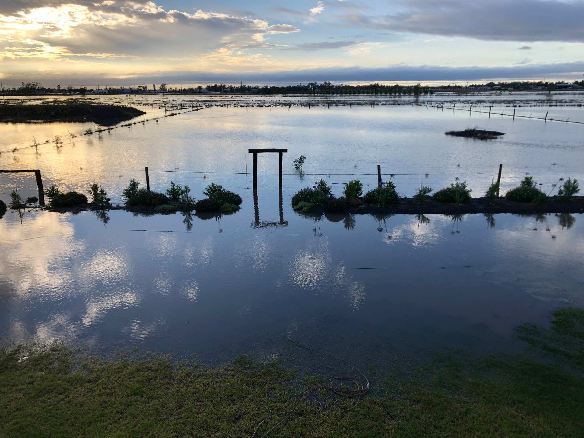 Flash flooding washes cars off roads in Queensland's south as the north