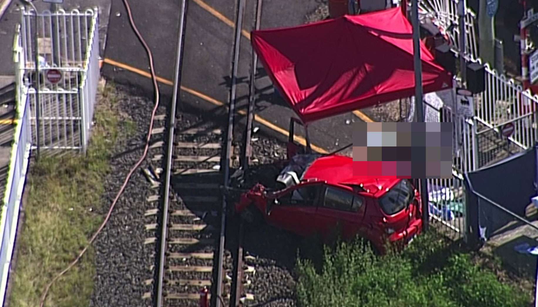 Woman killed as her car is hit by a train at a levelcrossing near