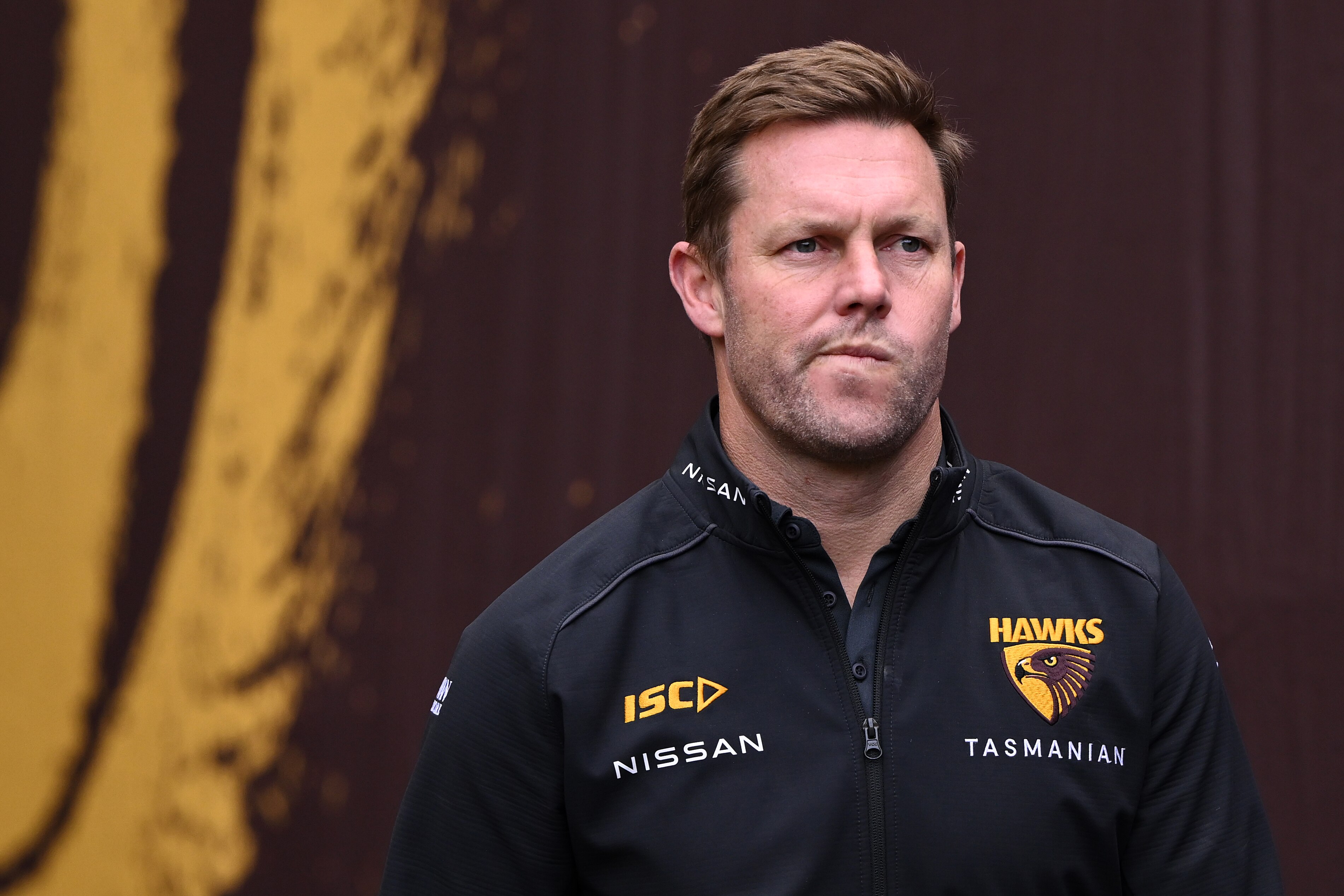 Hawks AFL coach Sam Mitchell decries racism after social media abuse of a player