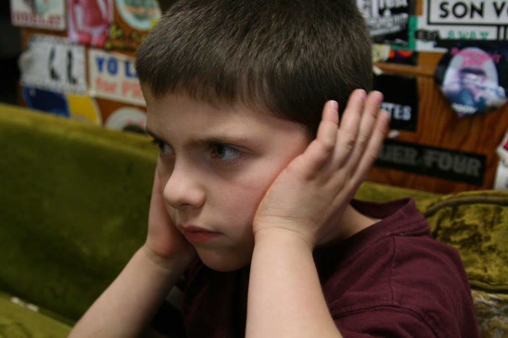 covering his ears Even though he had ear plugs in. sharyn morrow