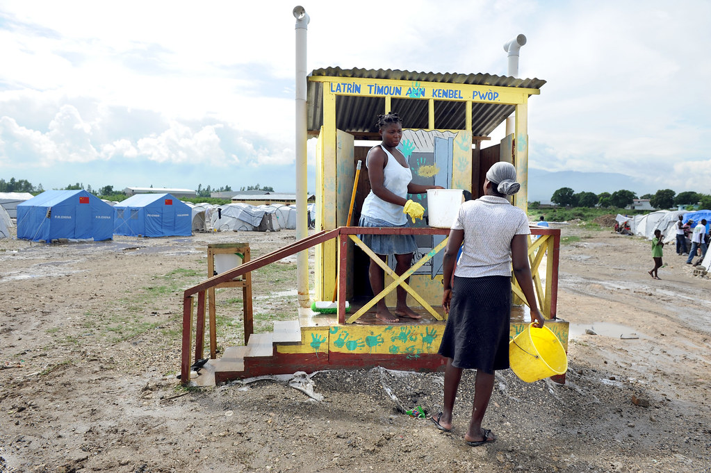 Cleaning latrines Women clean a latrine at a camp in Port… Flickr