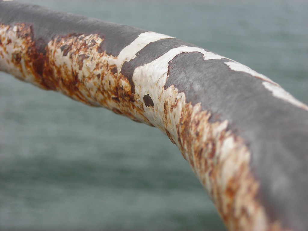Peeling railing Weathered and peeling paint on a railing. Craig A