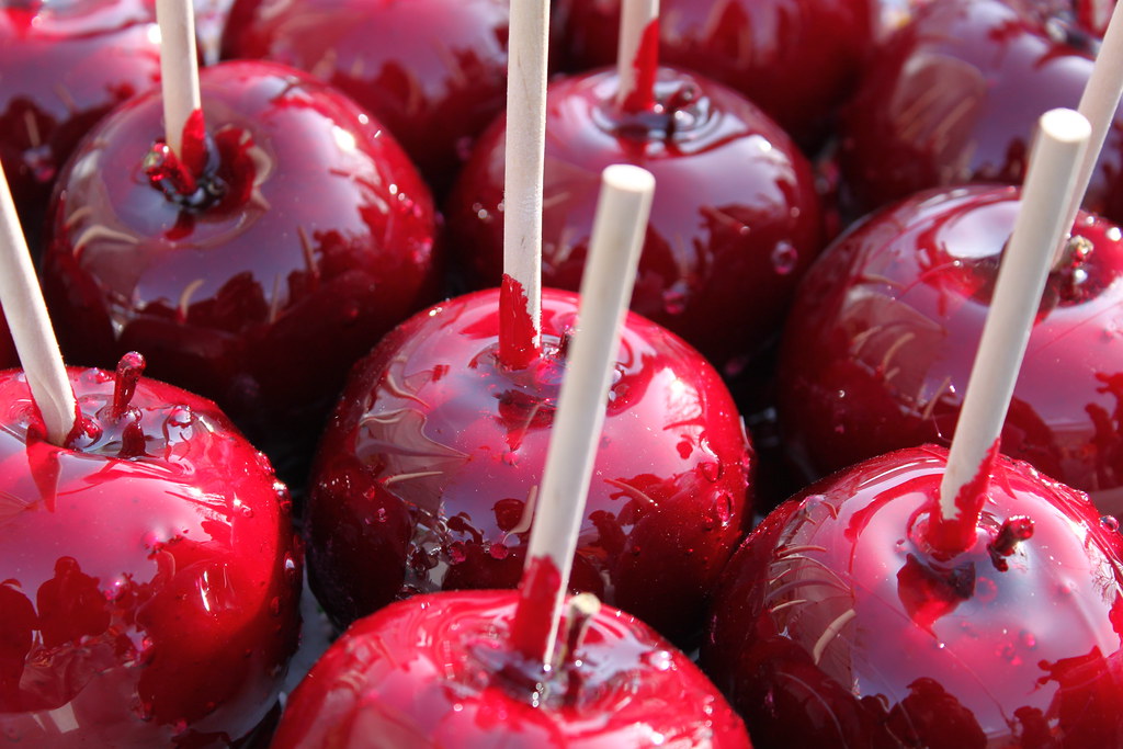 Candy Apples A table full of bright red candy apples draws… Flickr