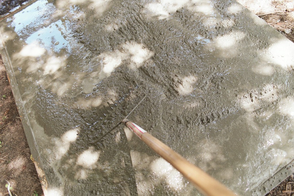 concrete for the chicken coop foundation raking Sarah Gilbert Flickr