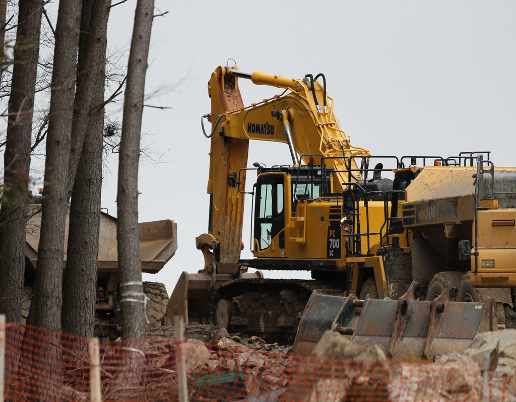 Komatsu Yellow. Komatsu PC700LC being used to clear rock i… Flickr