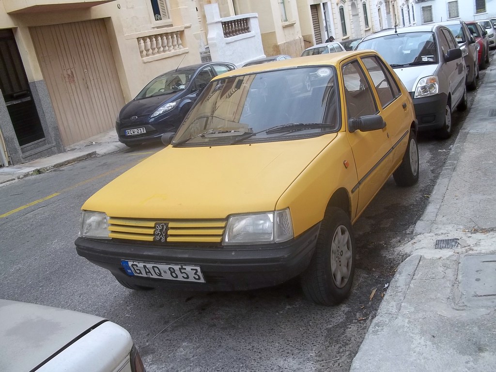 Yellow Peugeot 205 1 205's are very common in Malta, espe… Flickr