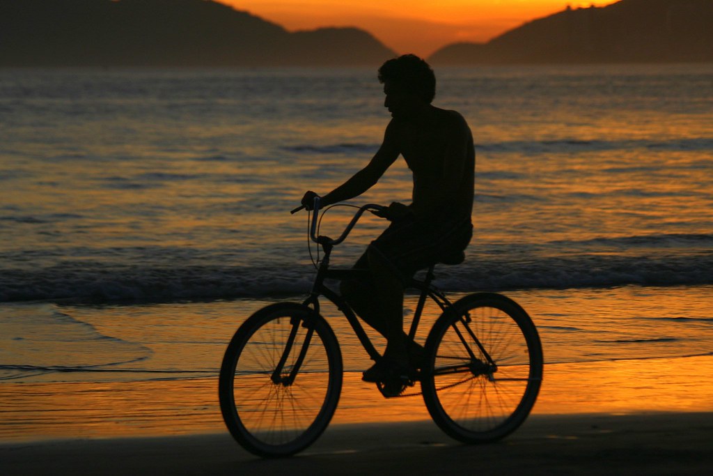 Man riding bike at the beach at sunset a photo on Flickriver