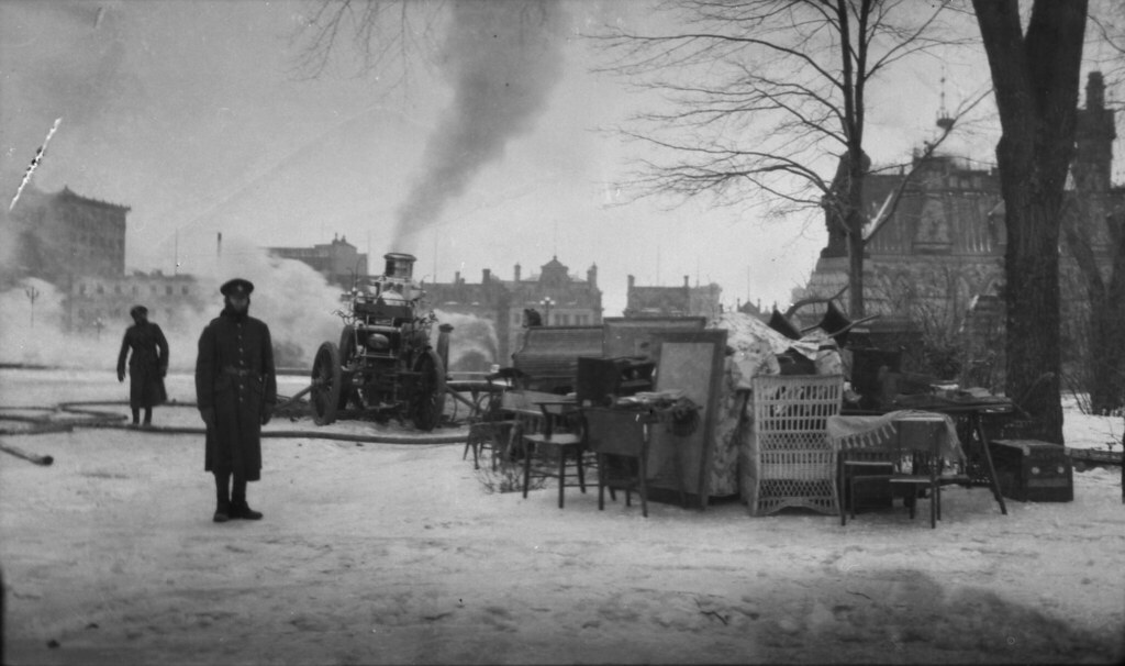 A soldier guarding furniture that was saved from the burni… Flickr