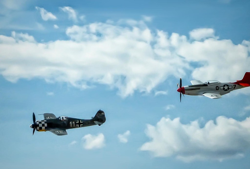 A vintage WWII aircraft gives chase during a simulated dogfight at the