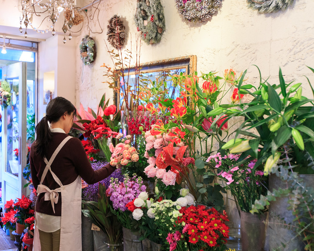 Japanese florist taking care of flowers in her flower shop… Flickr