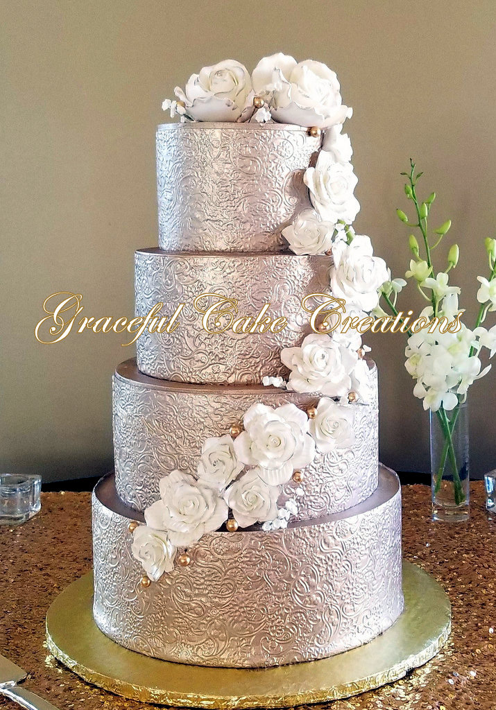 Elegant Gold Wedding Cake with an Embossed Floral Design A… Flickr