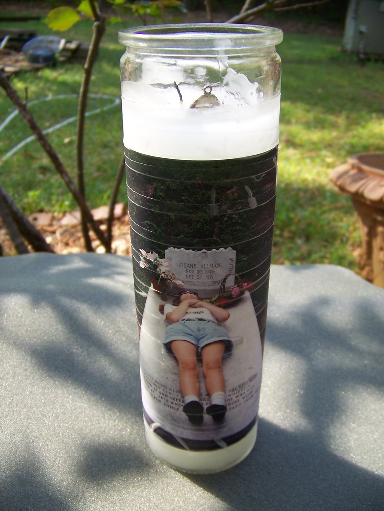 Huh? Candle with a medallion, and wrapped in a photo of so… Flickr