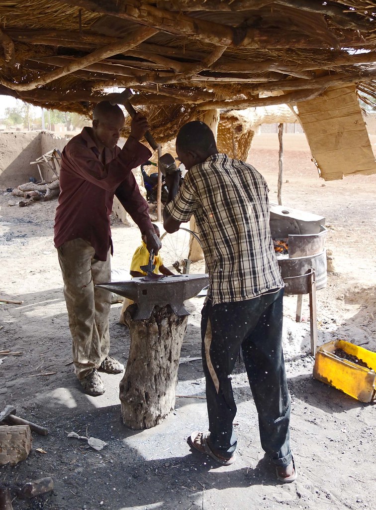 Blacksmiths at work producing crude adzes Sprott Global Research Flickr
